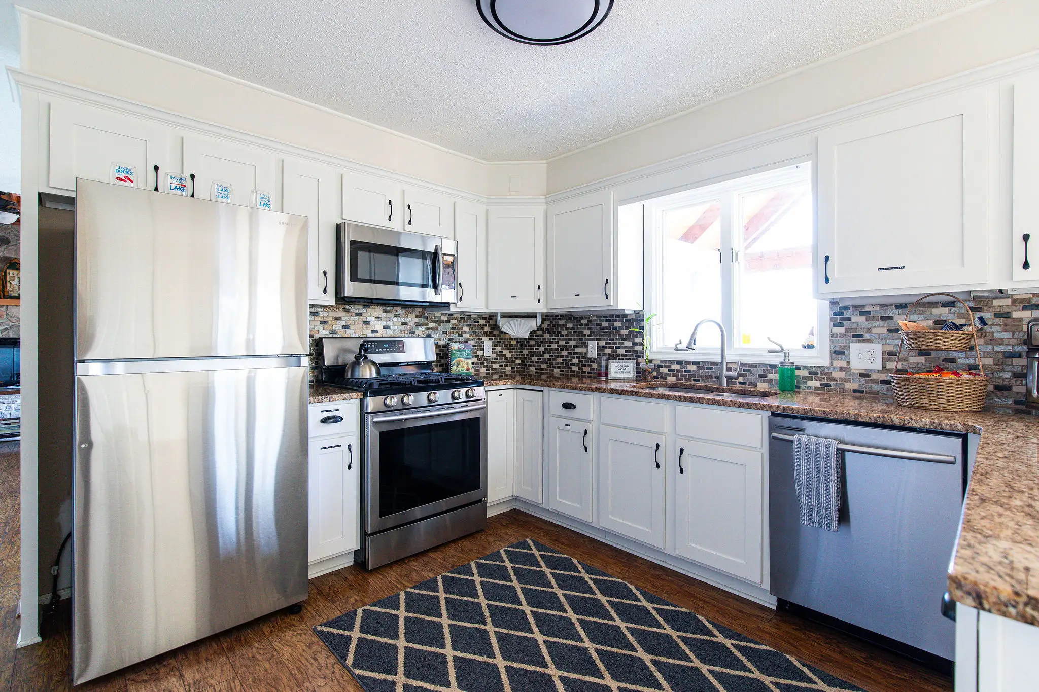 Kitchen with stainless steel appliances and granite counters