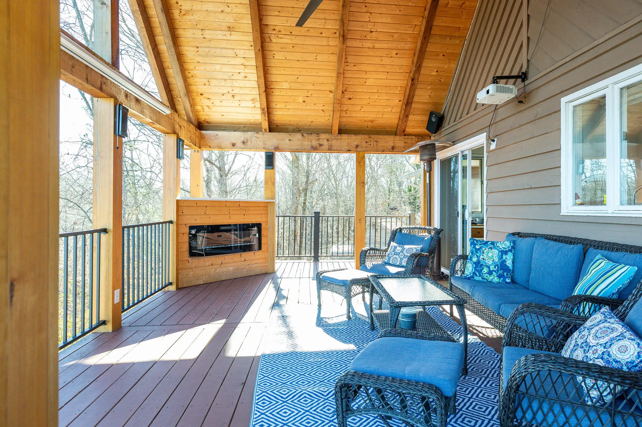 Covered porch seating around the outdoor fireplace