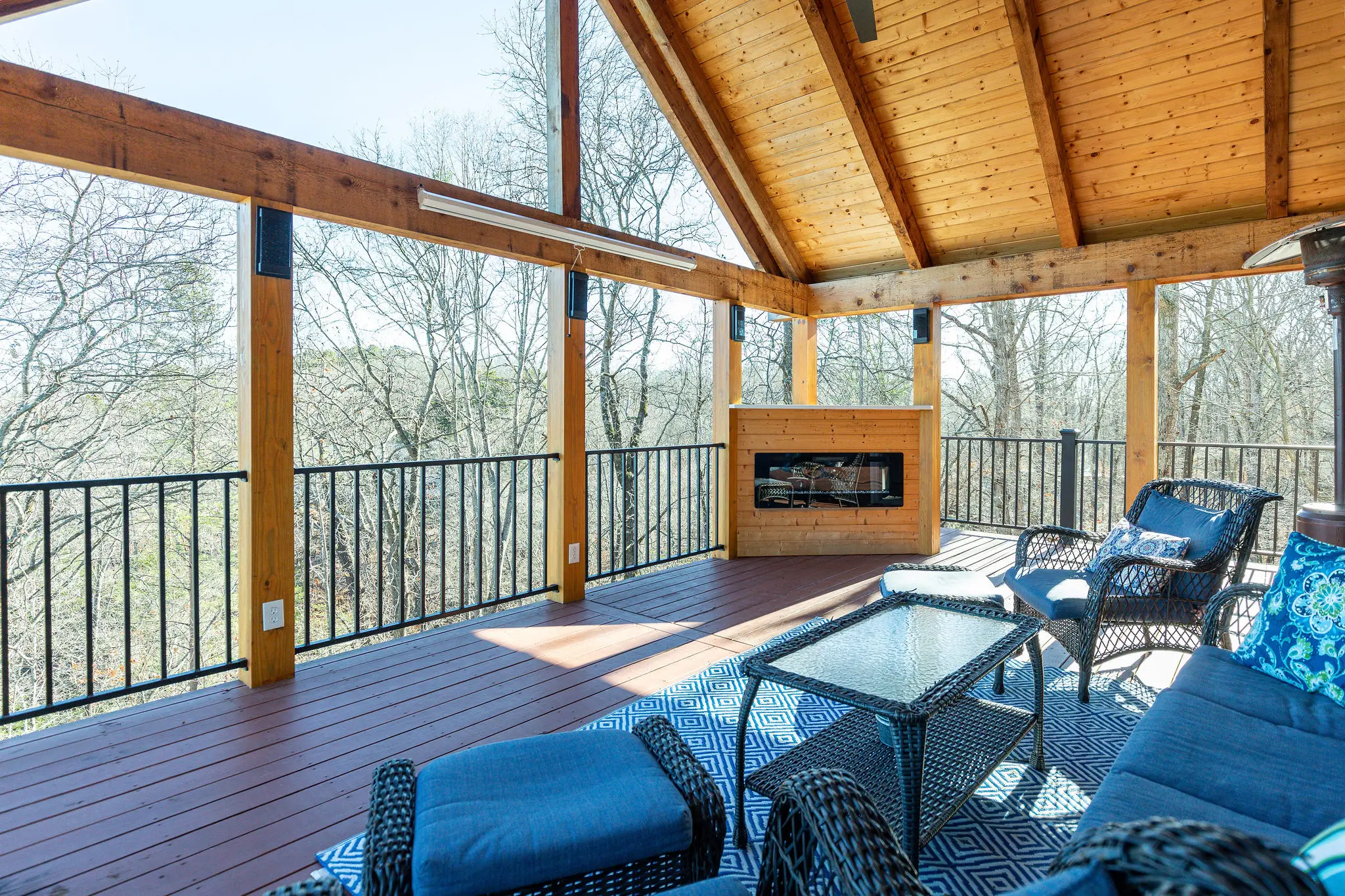 Covered porch lounge with sofas and ottomans
