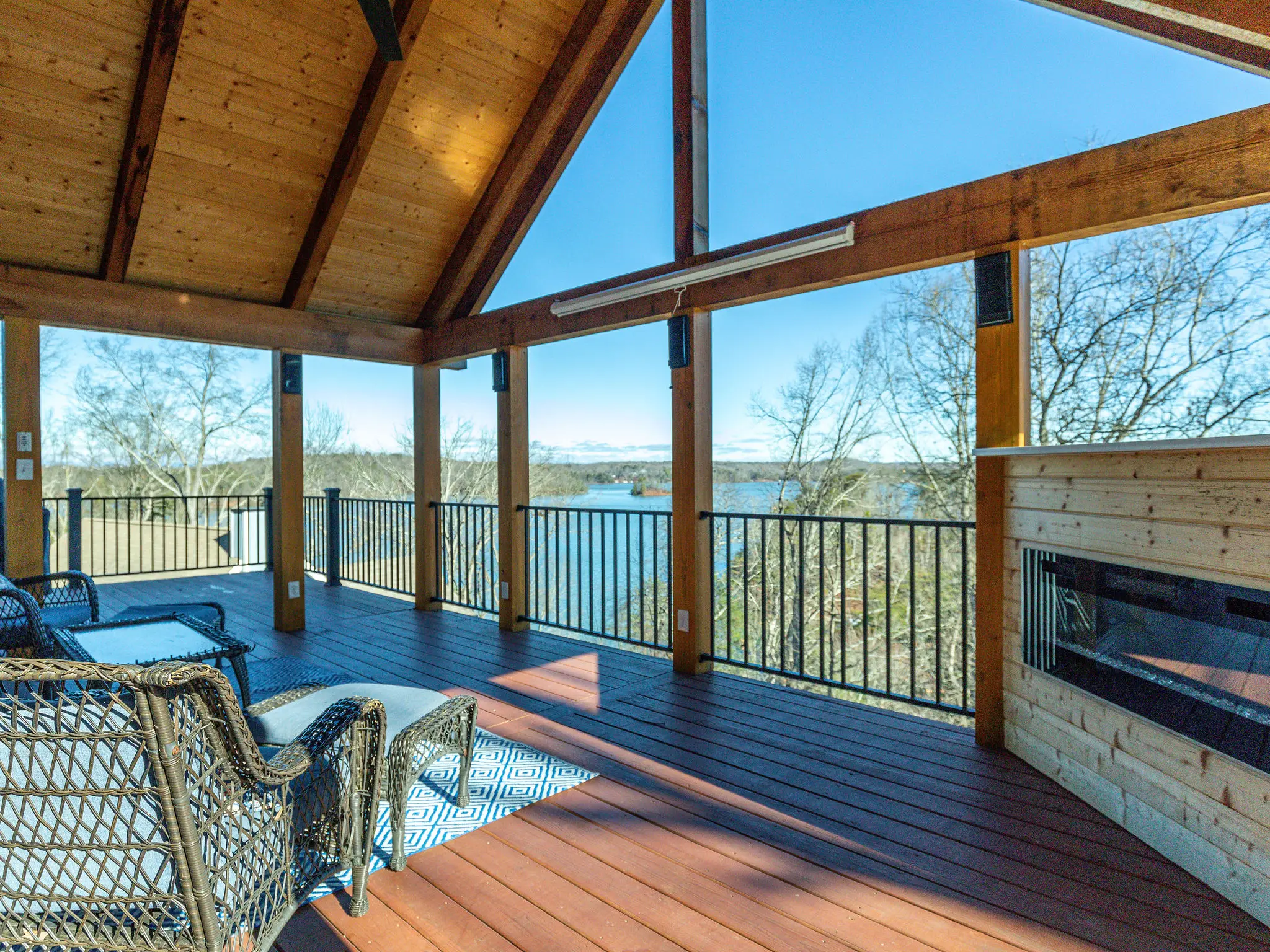 Covered porch with vaulted wood ceiling framing a view of Lake Lanier