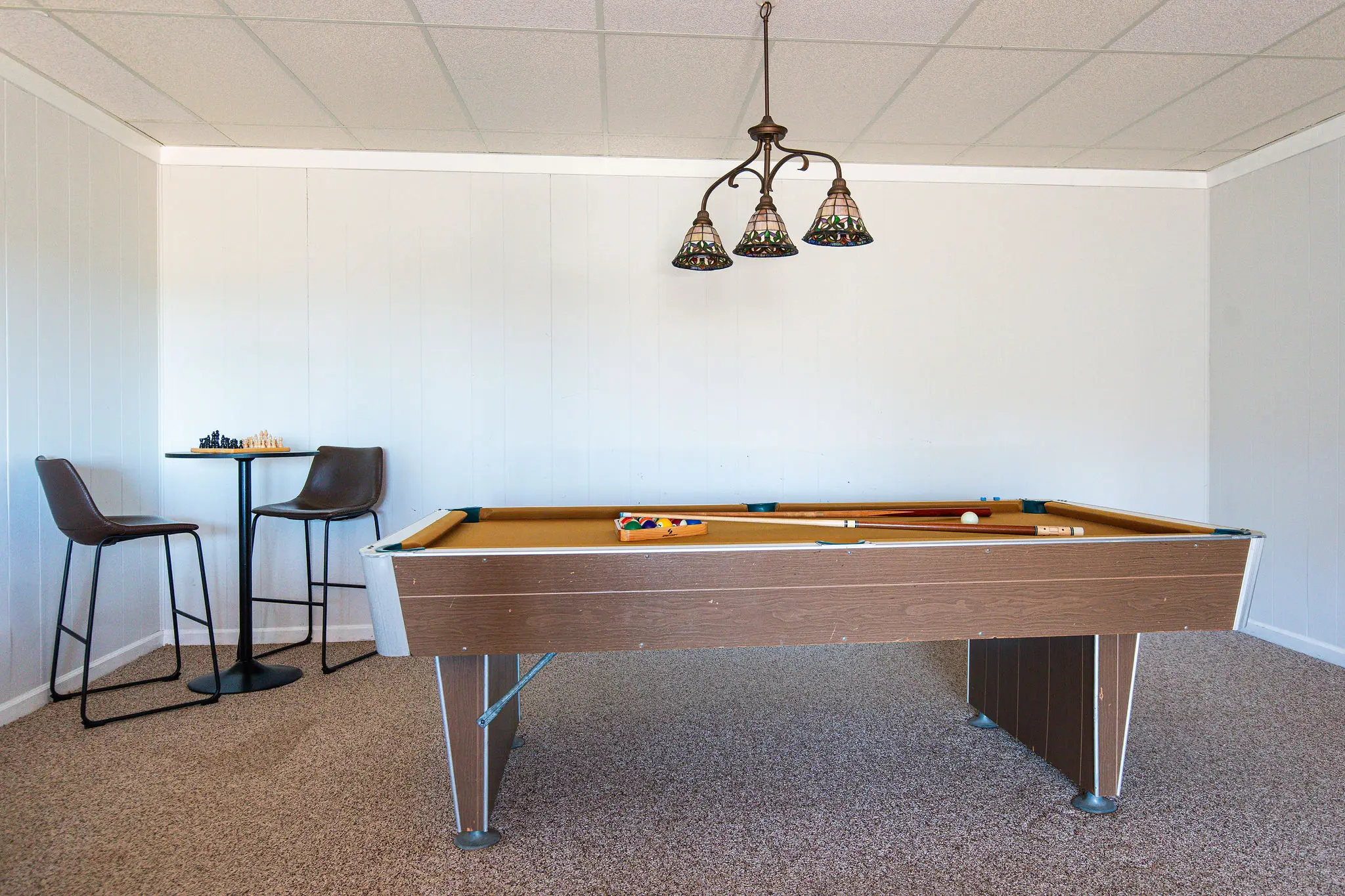 Game room with pool table and bar-height table