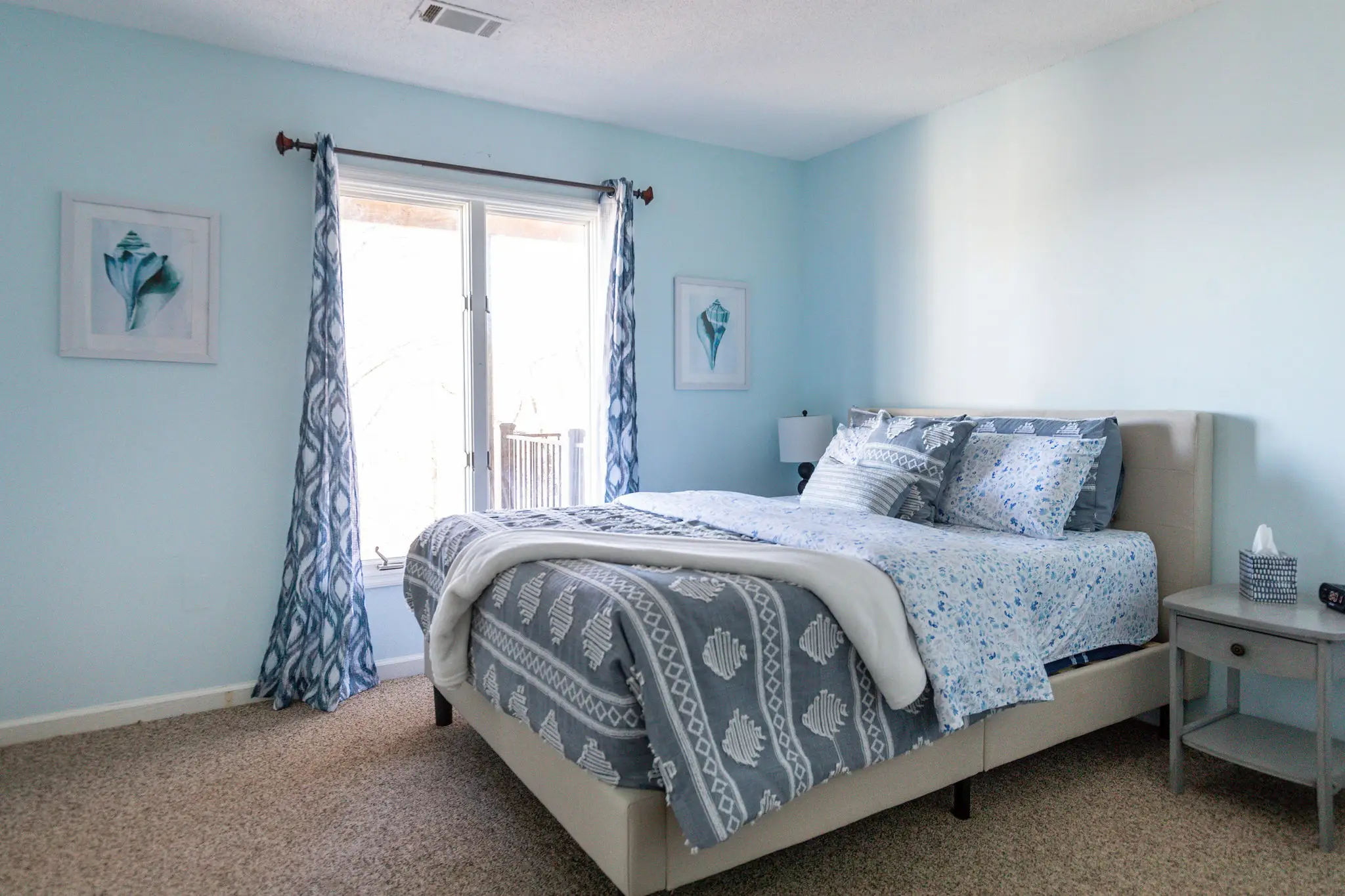 Bedroom with queen bed and door to the outside