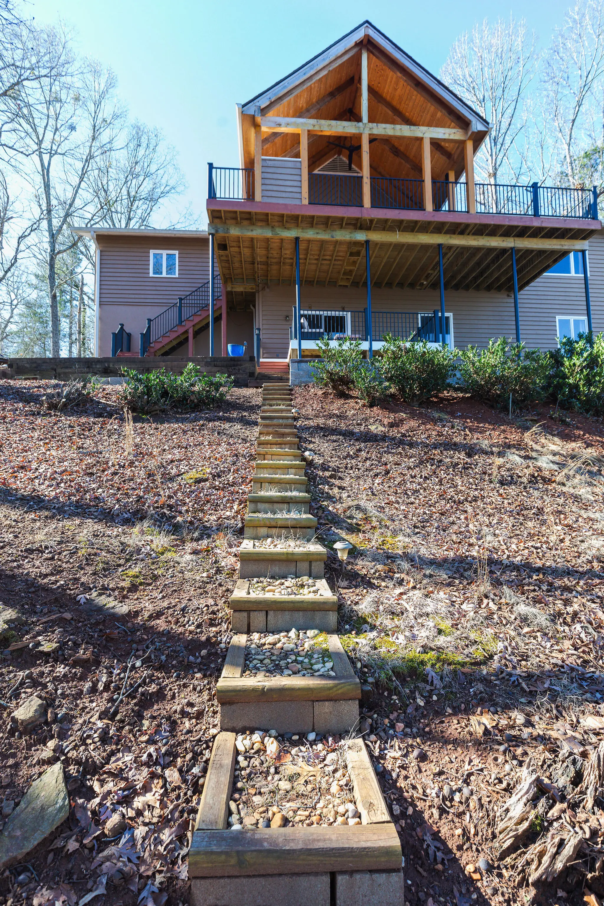 The house seen from the lake side, with steps leading up from the dock path