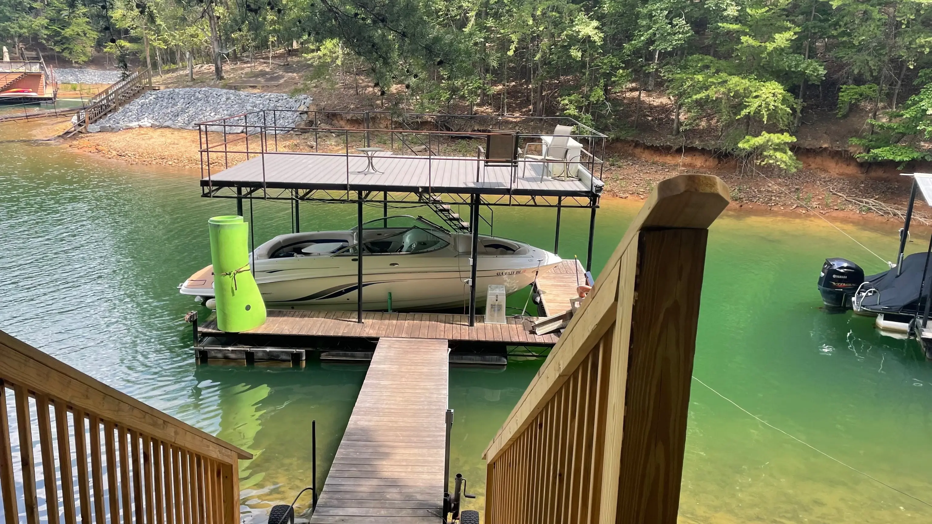 Wooden stairs down to the private dock and green summer water