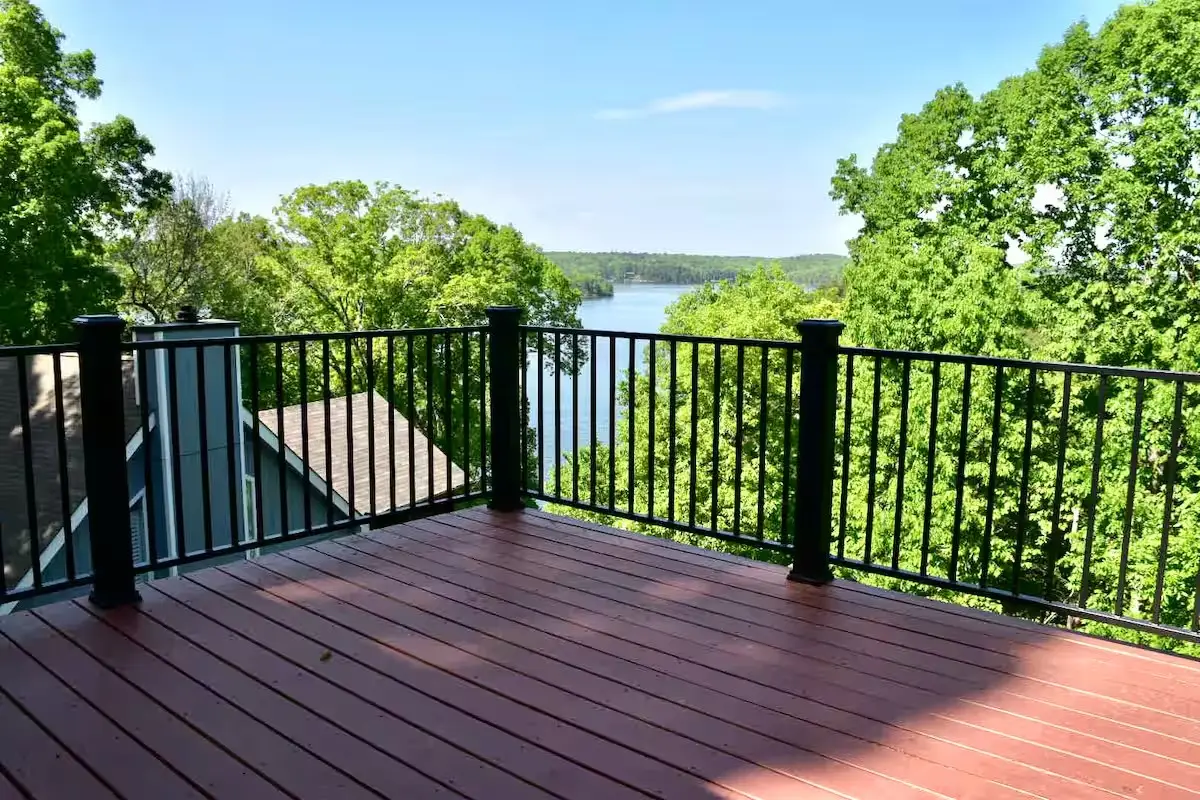 Open deck in summer with the lake through the trees