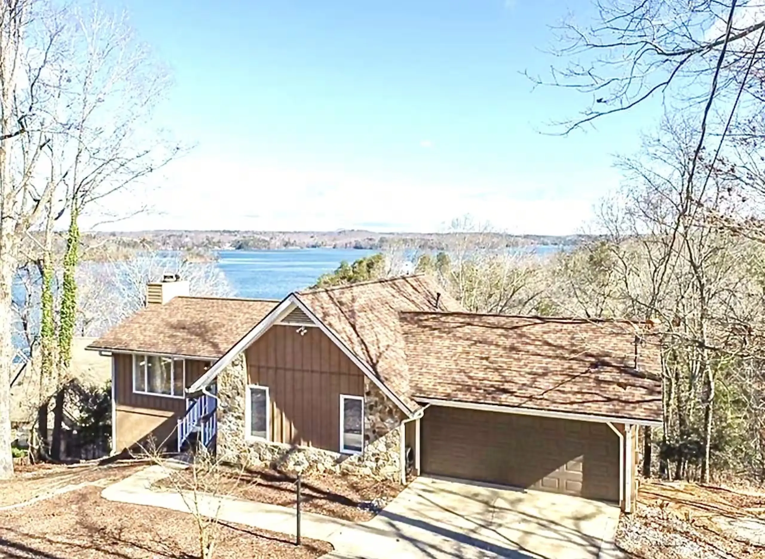 The house from the street with the lake beyond